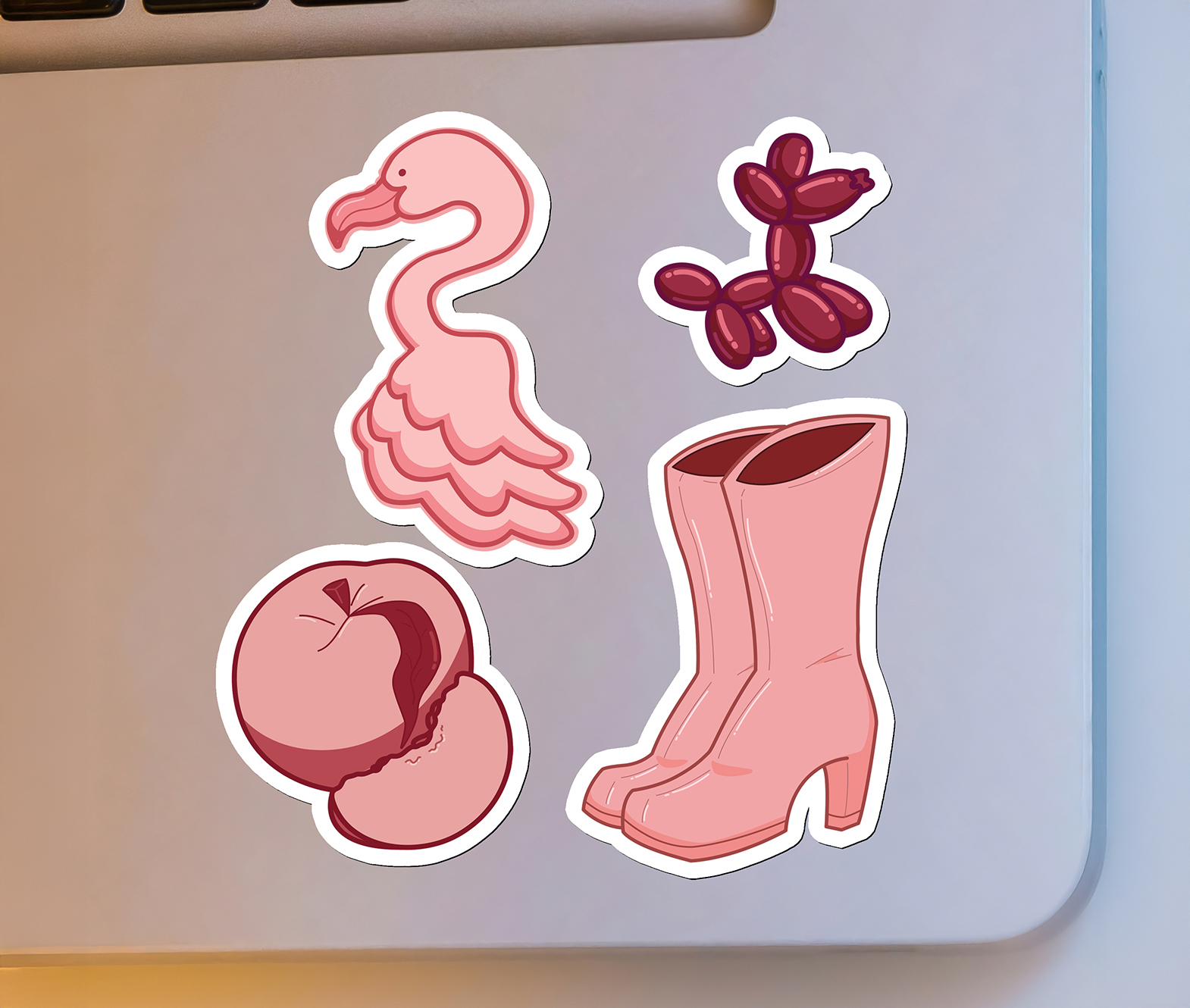 A mockup of stickers made in pre-press featuring a pink theme, made in Illustrator and mocked up in Photoshop.